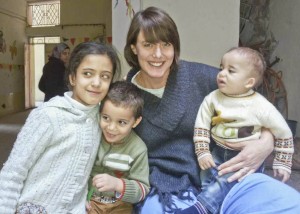 Kristin Hoops, RN, with refugee children in Jordan.
