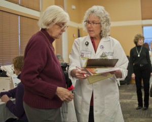 Community Outreach Nurse Brenda Schultz, RN, discusses health questions with a guest.