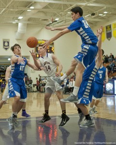 Bay’s Brandon Morriss (12) and Rex Sunahara (24) battle for the ball with Avon’s Zack Torbert. 