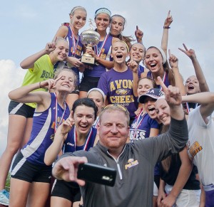 Avon’s girls coach Sam Ulery sets up a team picture with his cell phone.