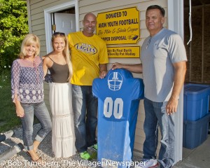 Sheila, Madison and Mike Cooper with Mayor Bryan Jensen at the new youth football equipment shed.