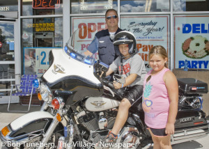 Officer Riss with Dylan Walton (on motorcycle) and Mya Marcicky.