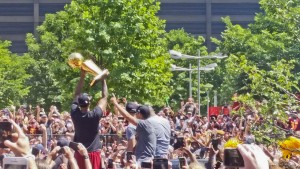 Cavs players hold up the Larry O'Brien Trophy during the parade.