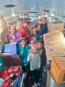 Westlake students ready to unload donations from school bus for May Dugan Center.